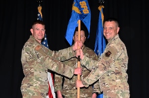 The Security Forces Group commander passing the squadron guideon to the new squadron commander.