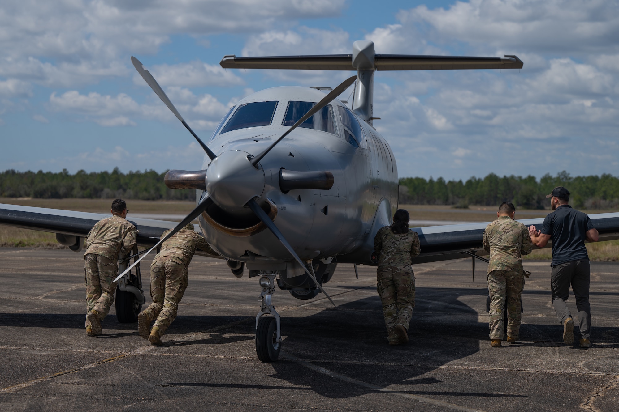 U.S. Airmen assigned to the 1st Special Operations Wing push a U-28A Draco during a joint unit base exercise near Hurlburt Field, Florida, March 25, 2025.