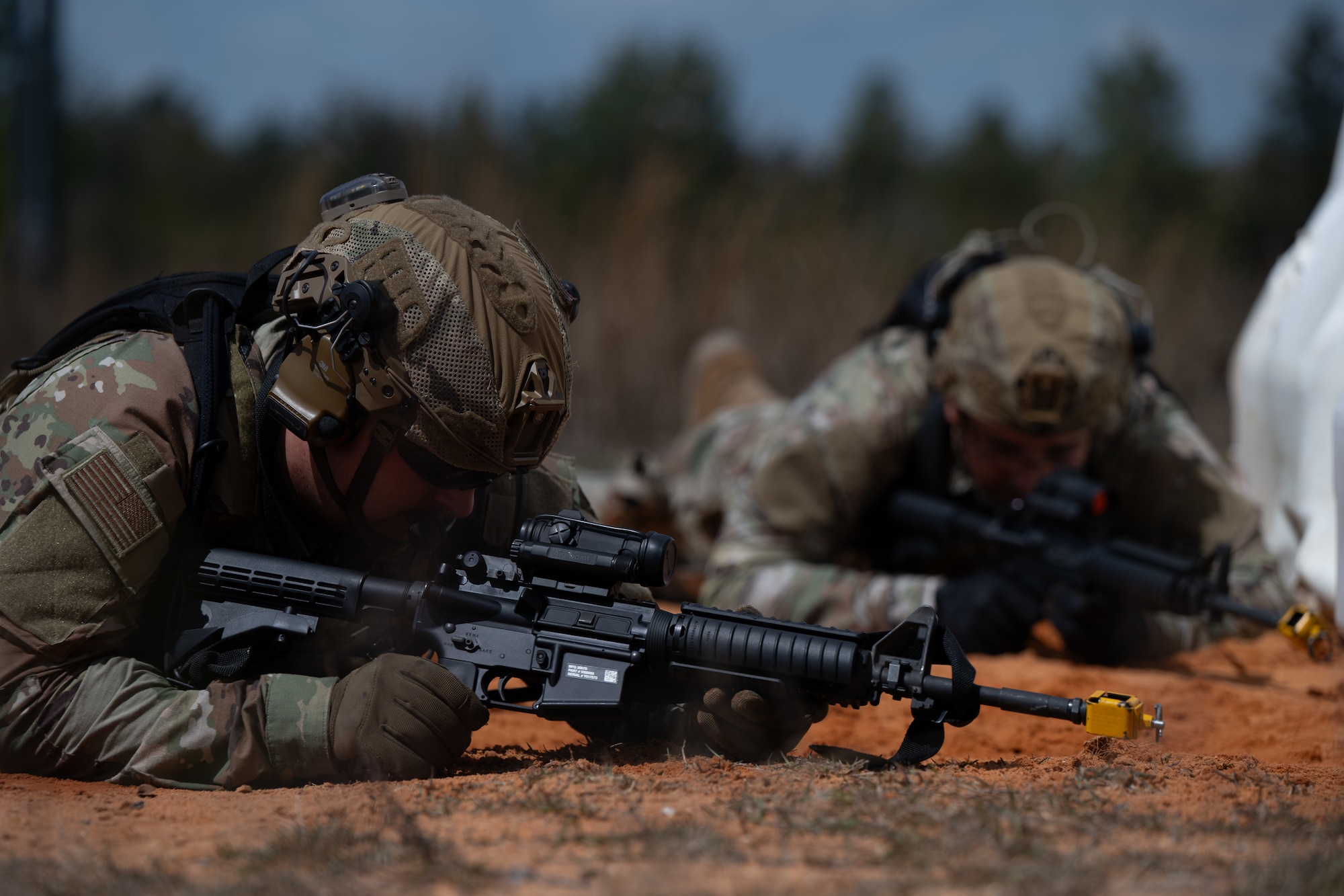 U.S. Airmen assigned to the 1st Special Operations Wing take cover after a simulated explosion during a joint unit base exercise near Hurlburt Field, Florida, March 25, 2025.