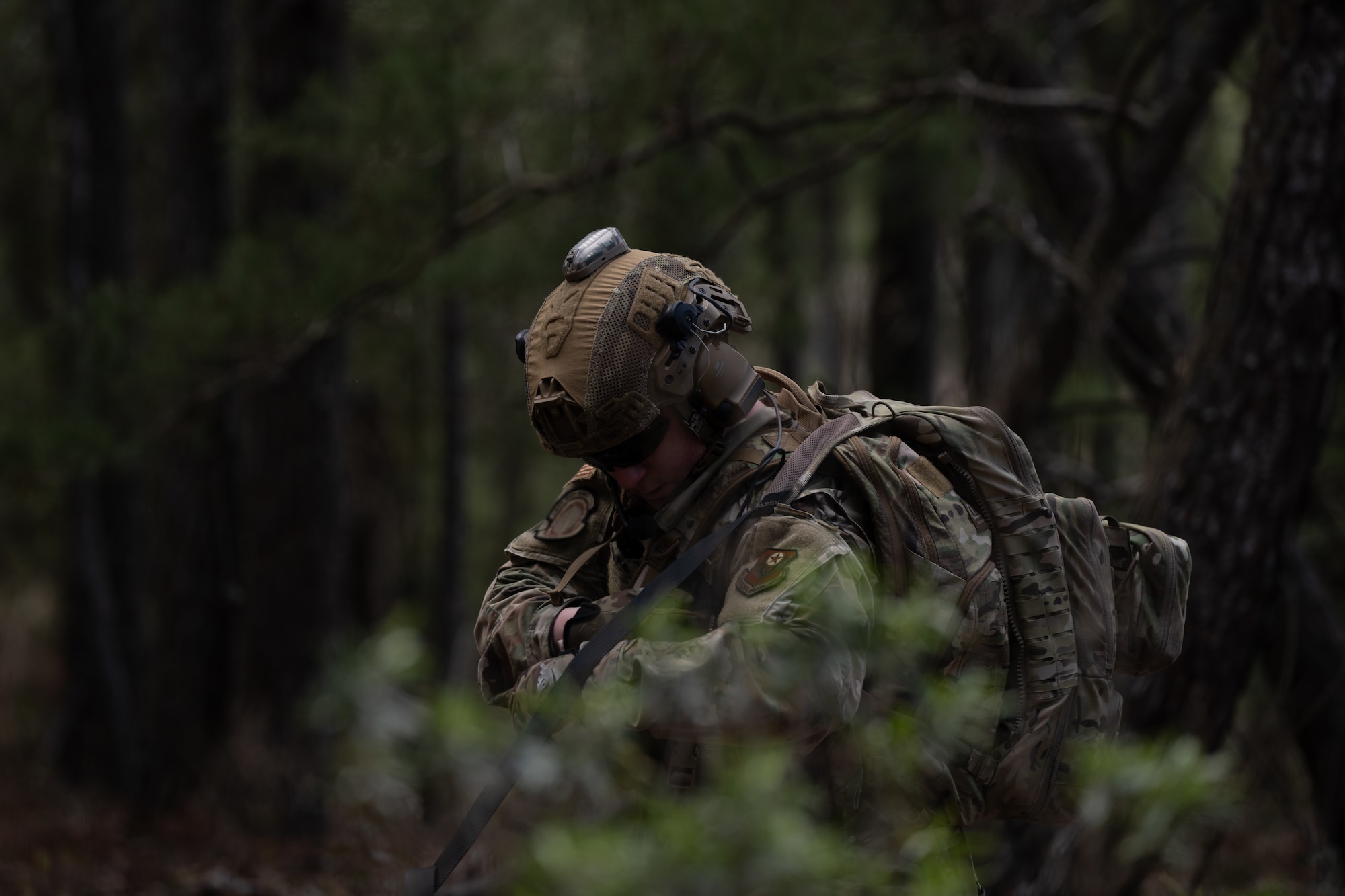 A U.S. Airman assigned to the 1st Special Operations Wing patrols an area during a joint-unit base exercise near Hurlburt Field, Florida, March 25, 2025.