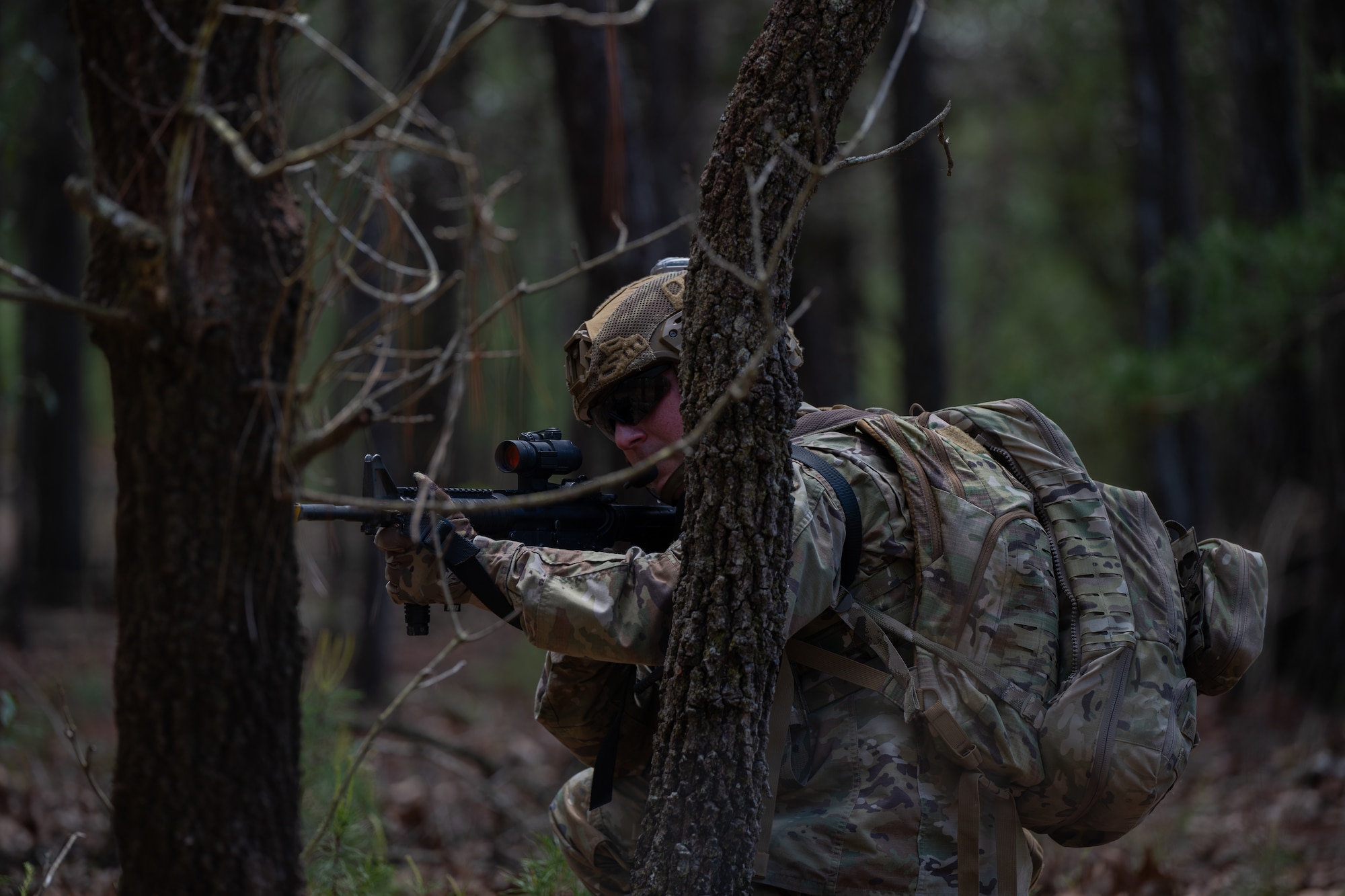 A U.S. Airman assigned to the 1st Special Operations Wing holds a defensive position during a joint unit base exercise near Hurlburt Field, Florida, March 25, 2025.