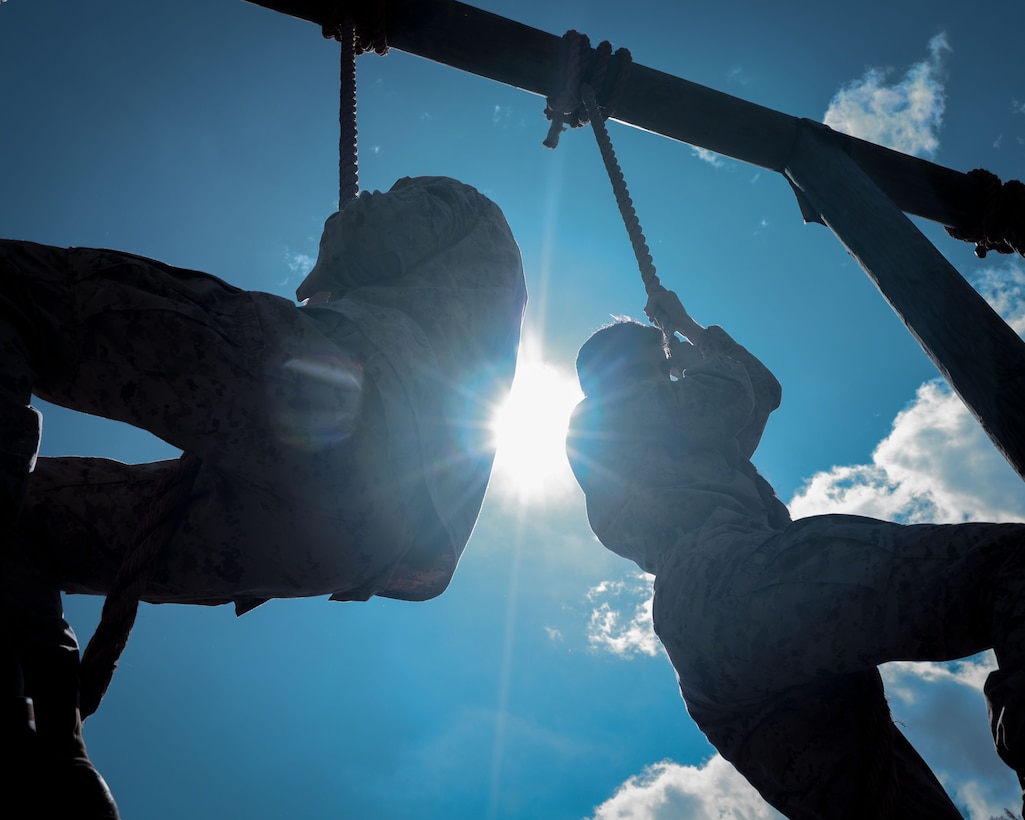 U.S. Marines with Alpha Company, Marine Barracks Washington, climb the obstacle course rope at Marine Corps Base Quantico, Virginia, April 16, 2025. The course tested Marines’ physical endurance and resilience, essential components of combat conditioning.