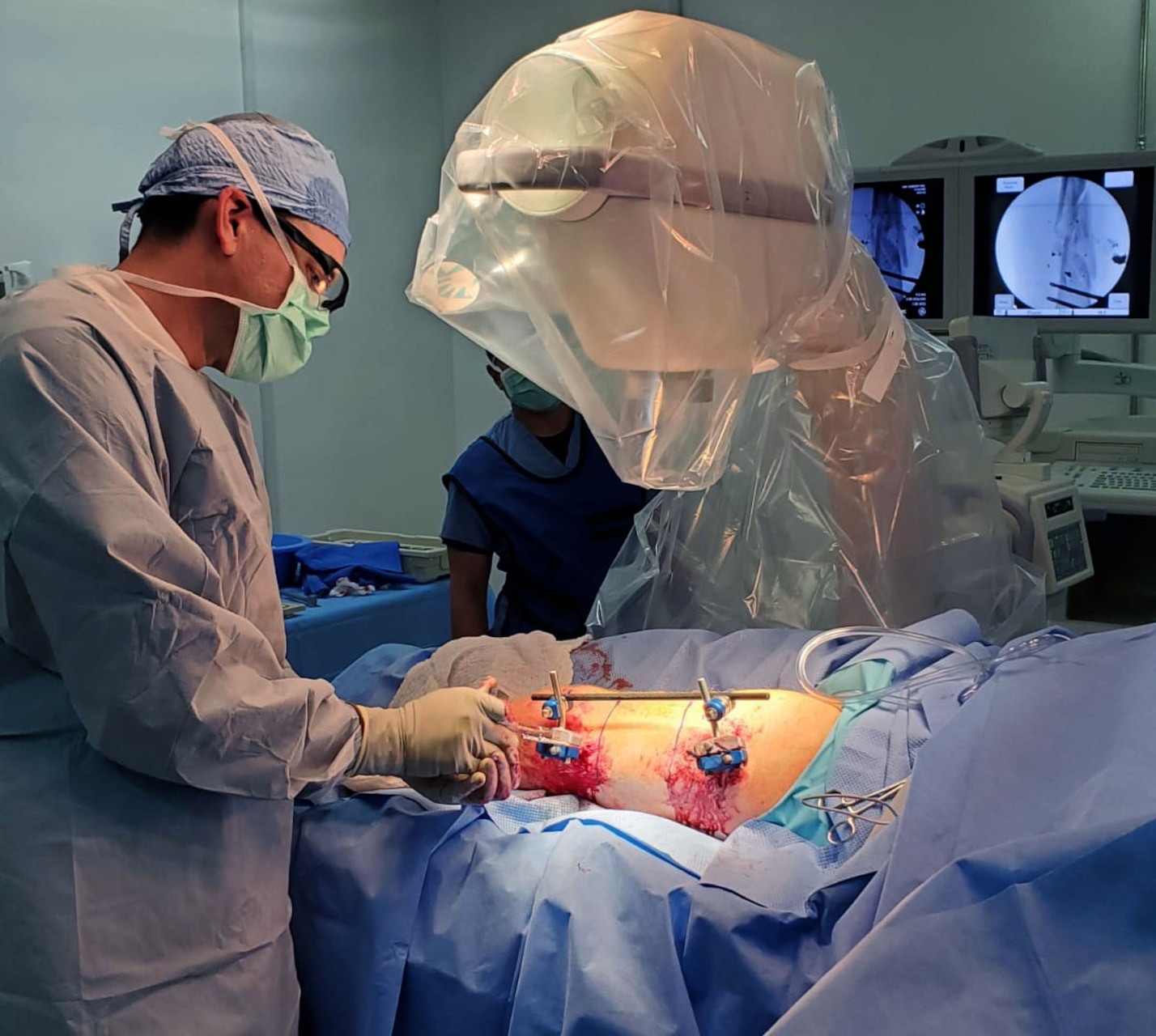 U.S. Navy Cmdr. Scott Trask, a general surgeon, performs an external fixation of a femur at the Expeditionary Medical Facility (EMF) at Camp Lemonnier, Djibouti, on Sept. 7, 2020. The EMF is responsible for the care of thousands of personnel who occupy the base in and around the area of responsibility. Camp Lemonnier is an operational installation that enables U.S., allied and partner nation forces to be where and when they are needed to ensure security in Europe, Africa and Southwest Asia. (U.S. Navy courtesy photo)
