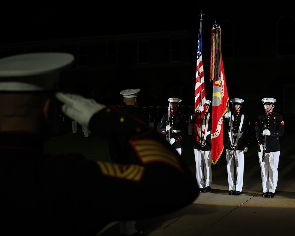 U.S. Marine Corps Master Sgt. Luke McNally, senior swordsman, parade staff, Marine Barracks Washington, salutes the colors during the Friday Evening Parade at Marine Barracks Washington, May 9, 2025. The hosting official for the parade was Assistant Commandant of the Marine Corps Gen. Christopher J. Mahoney, and the Guest of Honor was Elbridge A. Colby, Under Secretary of Defense for Policy. The parade highlights the Marine Corps' traditions and honors distinguished guests in a time-honored ceremony at Marine Barracks Washington.