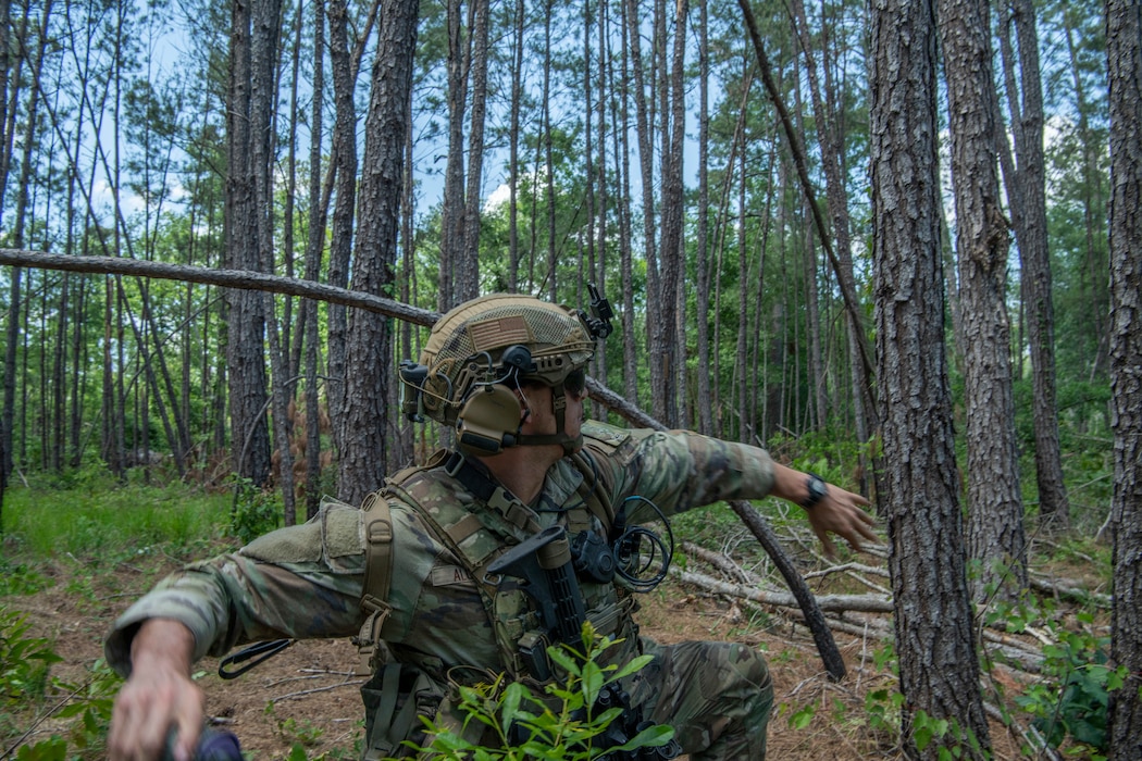 Airman throws a smoke grenade