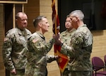 U.S. Army Col. Roger B. Zeigler, outgoing commander, 124th RTI, Vermont National Guard, passes the guide on at the 124th RTI Change of Command Ceremony at the 124th Regional Training Institute.