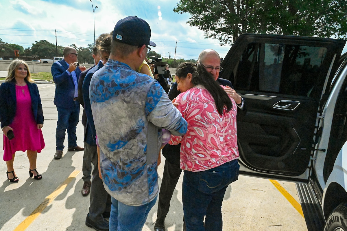 Tech. Sgt. Martha Rodriguez, a 433rd Security Forces Squadron fire team leader, embraces Jose Andrade, CEO of USAA, after receiving a new vehicle donated through USAA and the National Auto Body Council Recycled Rides program April 30, 2025 in San Antonio, Texas.