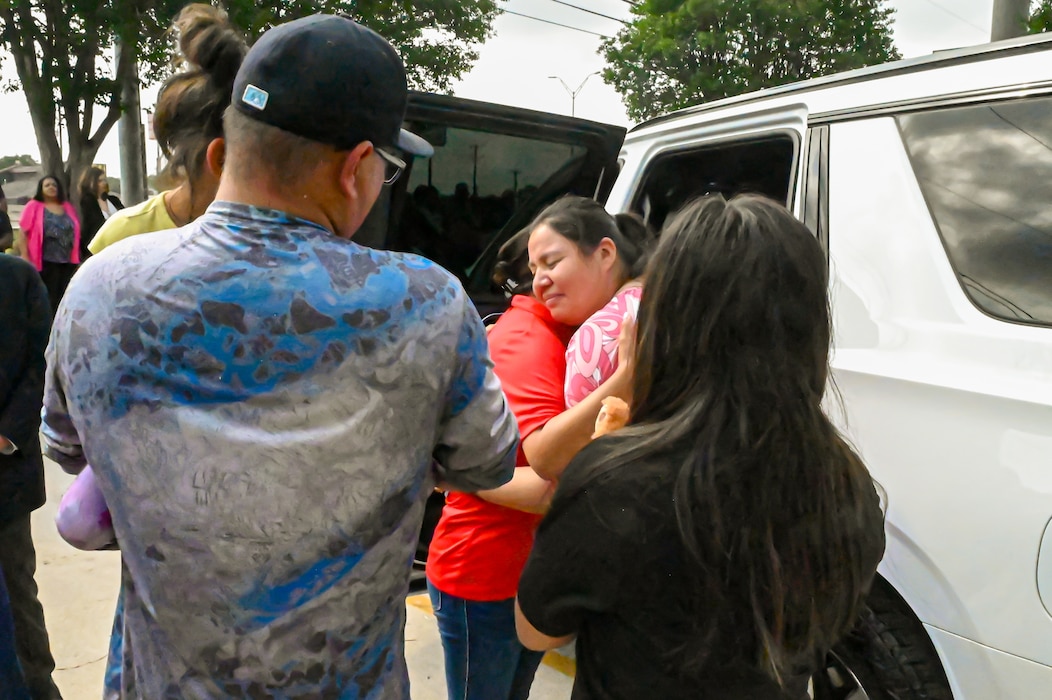 Tech. Sgt. Martha Rodriguez, a 433rd Security Forces Squadron fire team leader, embraces Lisa Hamlin, a retired 433rd Aeromedical Evacuation Squadron Chief Master Sgt., after receiving a new vehicle donated through USAA and the National Auto Body Council Recycled Rides program April 30, 2025 in San Antonio, Texas.