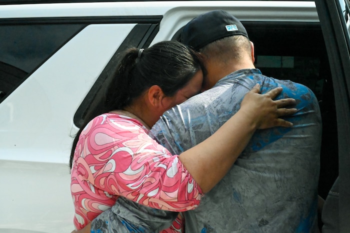 Tech. Sgt. Martha Rodriguez, a 433rd Security Forces Squadron fire team leader, embraces her husband Victor Rodriguez after receiving a new vehicle donated through USAA and the National Auto Body Council Recycled Rides program April 30, 2025 in San Antonio, Texas.