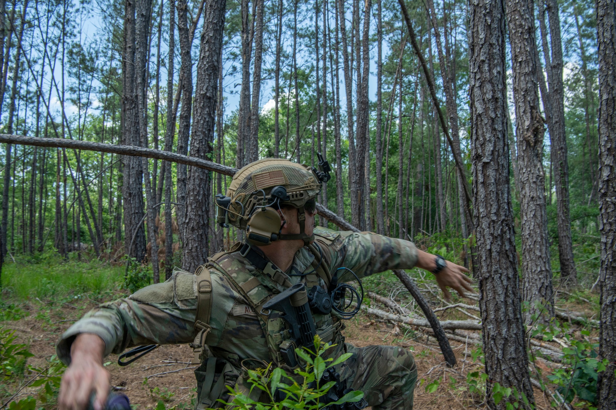 Airman throws a smoke grenade