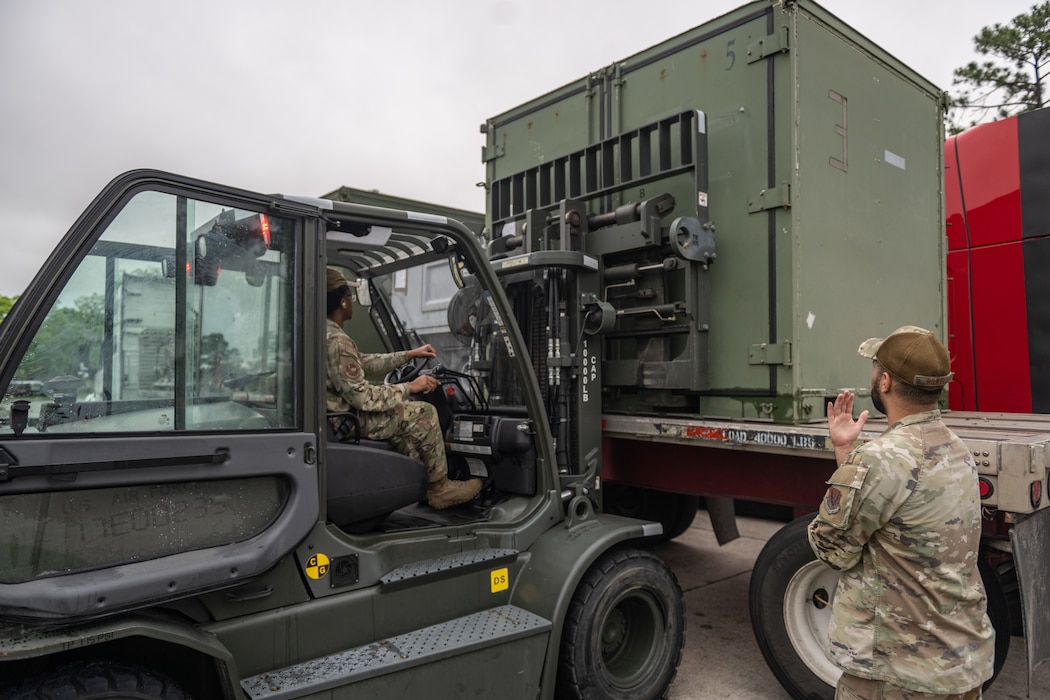 Airmen offload deployment cargo.