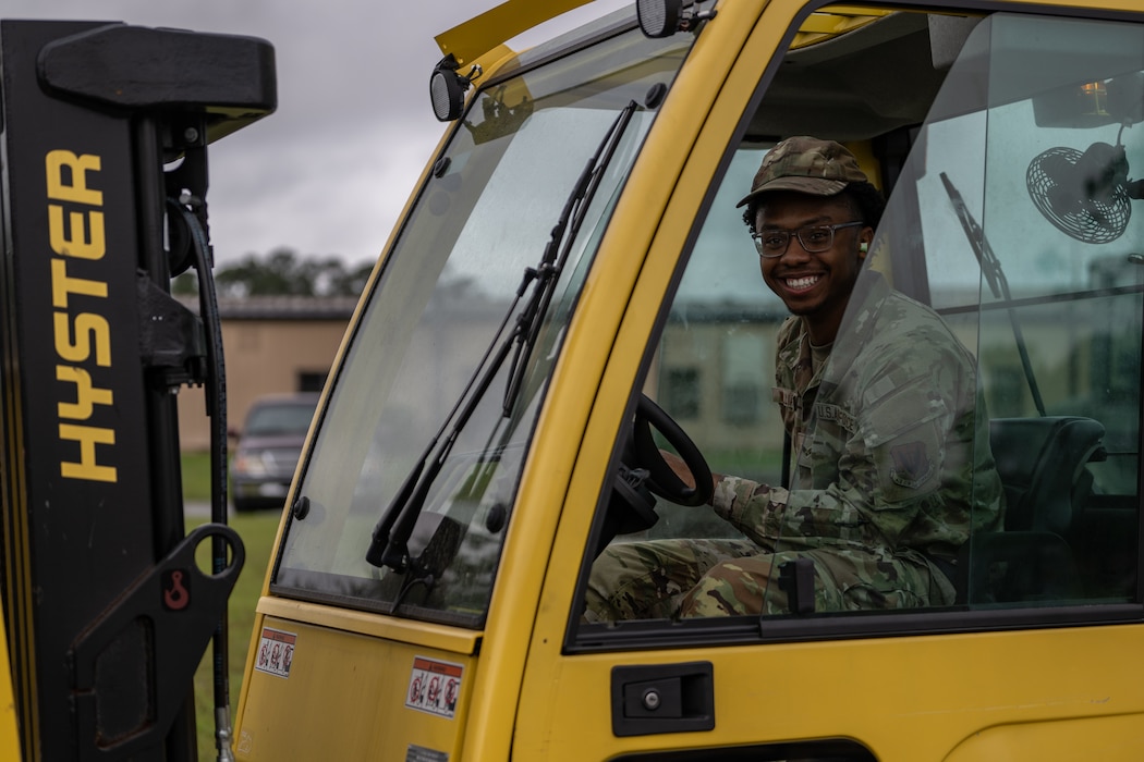 An Airman is in a forklift.