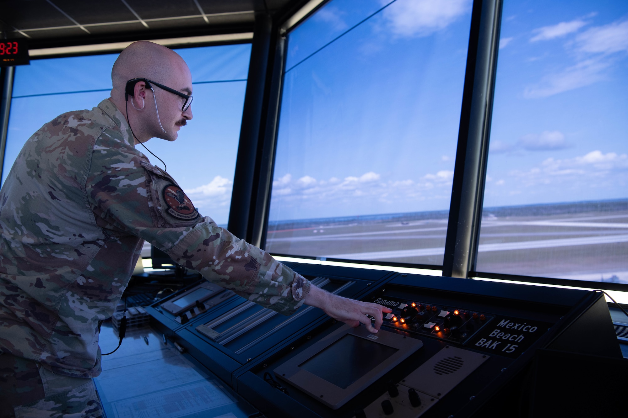 U.S. Air Force Senior Airman Quinn Hemmert , 325th Operational Support Squadron air traffic control apprentice, communicates with pilots and ground teams during Checkered Flag 25-2.