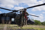 U.S. Air Force Staff Sgt. Robert Gabrielini, an emergency management specialist with the 105th Civil Engineer Squadron, New York Air National Guard, exits an UH-60 Black Hawk assigned to the Puerto Rico Army National Guard during the 2025 Virgin Islands and Puerto Rico emergency management Deployment for Training at Fort Allen, Juana Diaz, Puerto Rico, May 19, 2025. The 2025 VIPR EM DFT measured multiple ANG civil engineer squadrons’ mission readiness by simulating an austere location to prepare participating Airmen to execute the Agile Combat Employment Concept within the U.S. Air Force Indo-Pacific Command area of responsibility.  (U.S. Air National Guard photo by 1st Lt. Eliezer Soto)