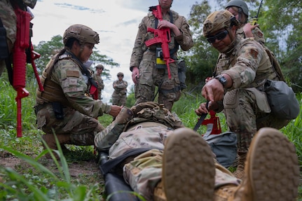 U.S. Air Force Staff. Sgt. Chastilynn Tittle, an emergency management specialist with the 154 Civil Engineer Squadron, Hawaii Air National Guard, left, and Staff Sgt. Ashviel Cruz Aponte, an emergency management specialist with the 156th Civil Engineer Squadron, Puerto RicoAir National Guard, strap an airman on a stretcher during the 2025 Virgin Islands and Puerto Rico emergency management Deployment for Training at Fort Allen, Juana Diaz, Puerto Rico, May 18, 2025. The 2025 VIPR EM DFT measured multiple ANG civil engineer squadrons’ mission readiness by simulating an austere location to prepare participating Airmen to execute the Agile Combat Employment Concept within the U.S. Air Force Indo-Pacific Command area of responsibility. (U.S. Air National Guard photo by 1st Lt. Eliezer Soto)