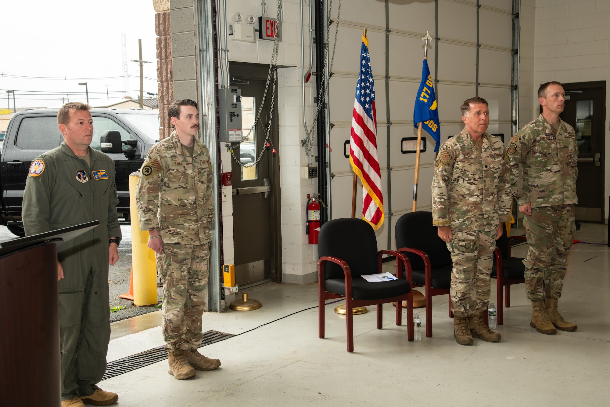 From left, U.S. Air Force Col. Benjamin Robbins, 177th Fighter Wing commander, Staff Sgt. Justin Kahill, 227th Joint Terminal Attack Controller, Lt. Col. Daniel Roske, 227th Air Support Operations Squadron (ASOS) commander, and Chief Master Sgt. Patrick Donohoe, 227th ASOS superintendent, stand at the position of attention during a Bronze Star Medal and Casing of the Colors Ceremony at the 177th FW, Egg Harbor Township, New Jersey, May 4, 2025. The Bronze Star is awarded to service members who distinguish themselves by heroic or meritorious achievement or service in a combat zone. The Casing of the Colors Ceremony marks a transition of a unit, whether that be inactivation, relocation, or deployment.