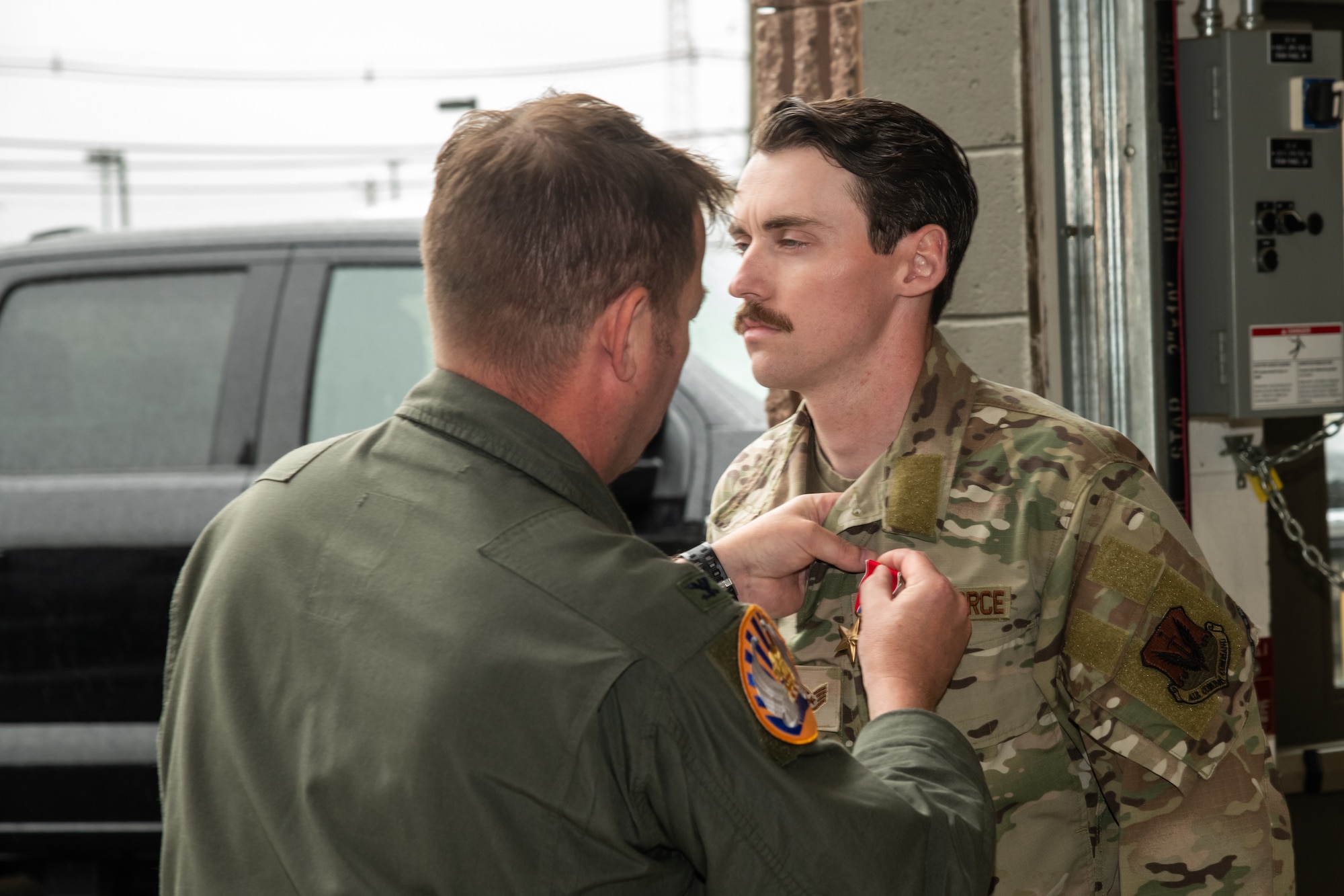U.S. Air Force Col. Benjamin Robbins, 177th Fighter Wing commander, left, pins the Bronze Star Medal on Staff Sgt. Justin Kahill, 227th Joint Terminal Attack Controller, during a Bronze Star Medal and Casing of the Colors Ceremony at the 177 FW, Egg Harbor Township, New Jersey, May 4, 2025. The Bronze Star is awarded to service members who distinguish themselves by heroic or meritorious achievement or service in a combat zone. The Casing of the Colors Ceremony marks a transition of a unit, whether that be inactivation, relocation, or deployment.