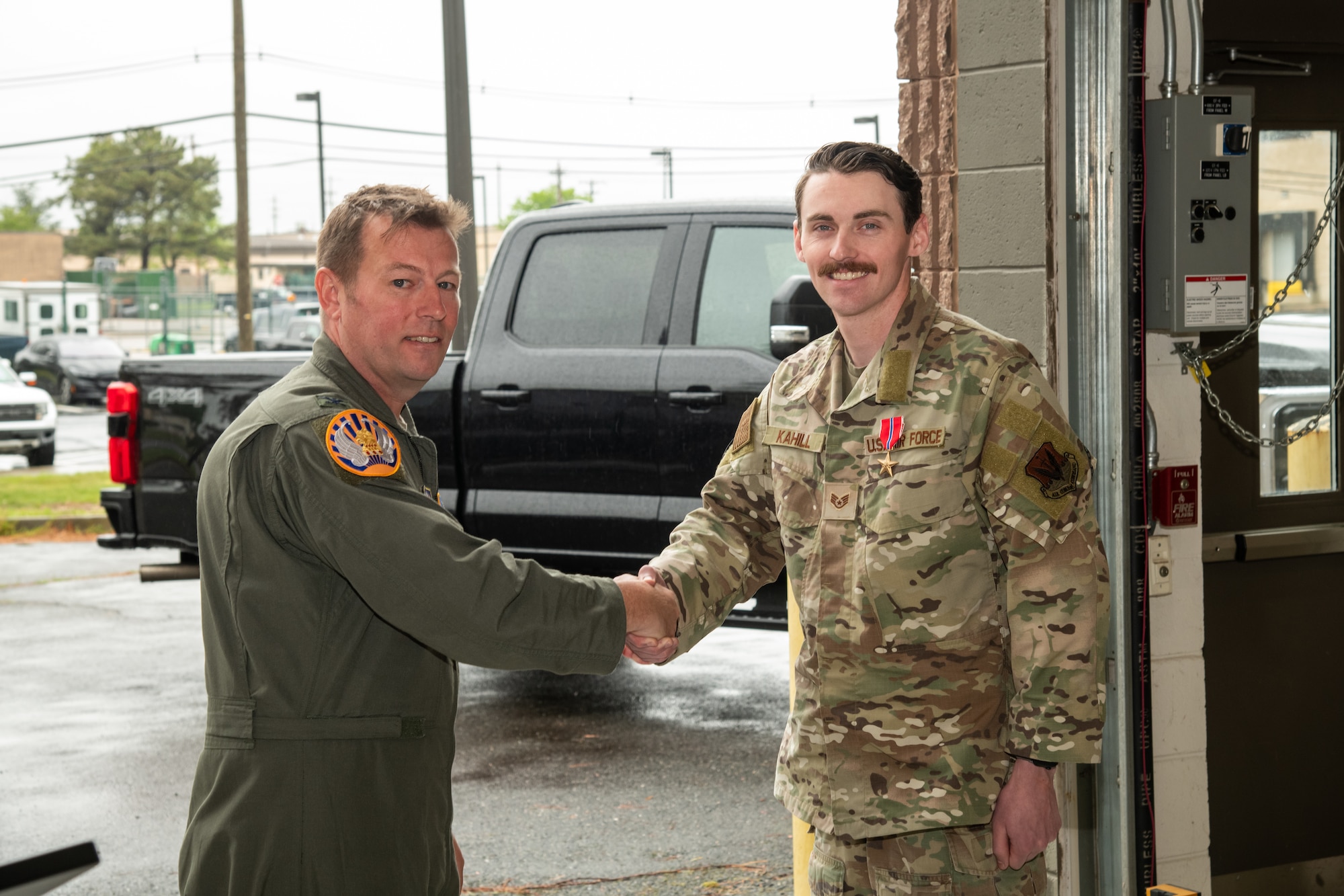 U.S. Air Force Col. Benjamin Robbins, 177th Fighter Wing commander, left, shakes hands with Staff Sgt. Justin Kahill, 227th Joint Terminal Attack Controller, during a Bronze Star Medal and Casing of the Colors Ceremony at the 177 FW, Egg Harbor Township, New Jersey, May 4, 2025. The Bronze Star is awarded to service members who distinguish themselves by heroic or meritorious achievement or service in a combat zone. The Casing of the Colors Ceremony marks a transition of a unit, whether that be inactivation, relocation, or deployment.