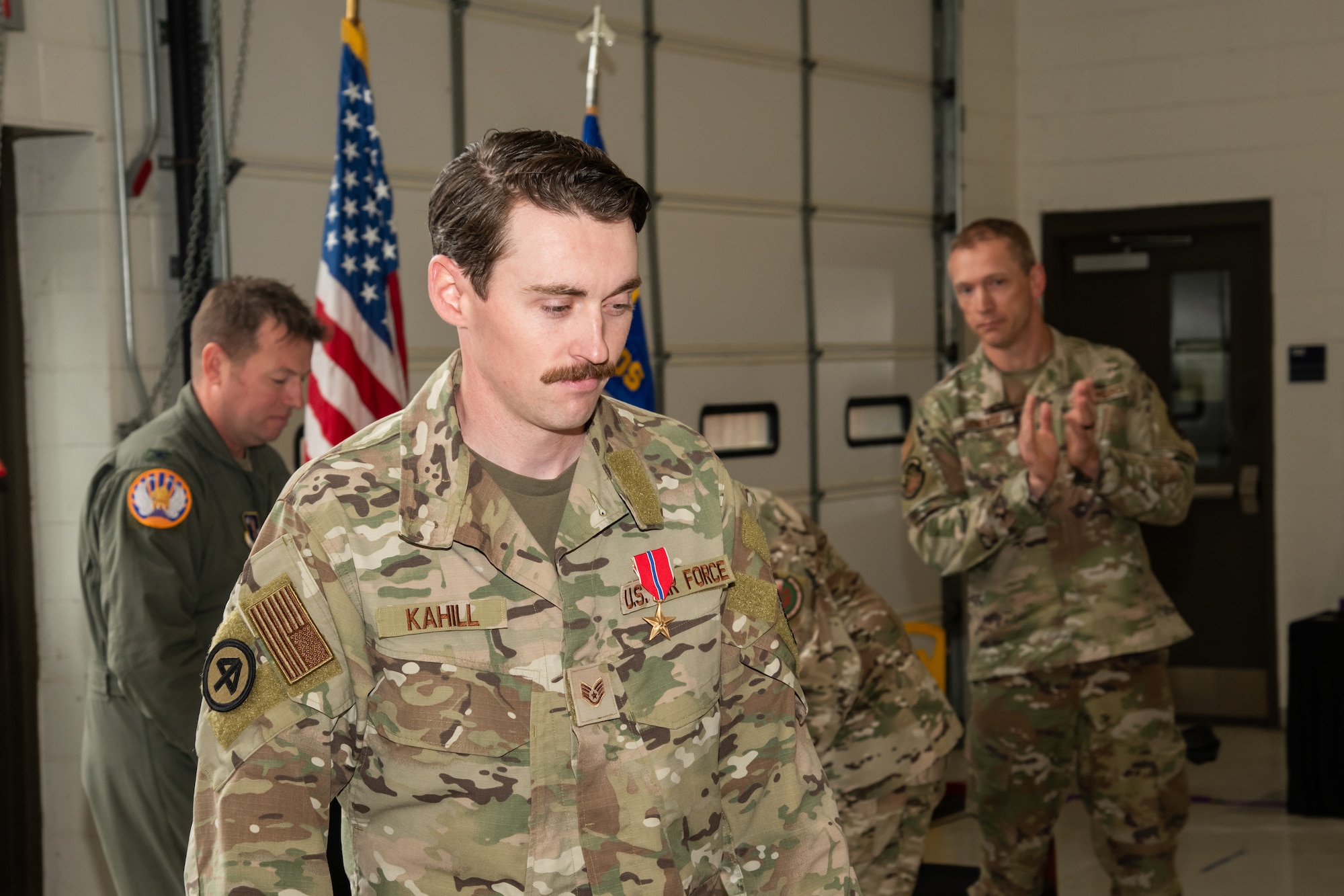 U.S. Air Force Staff Sgt. Justin Kahill, 227th Joint Terminal Attack Controller, walks back to his seat after being awarded the Bronze Star Medal at the 177th Fighter Wing, Egg Harbor, New Jersey, May 4, 2025. Kahill was awarded the Bronze Star Medal for his meritorious service in a combat zone from March 2024 to Nov. 2024.