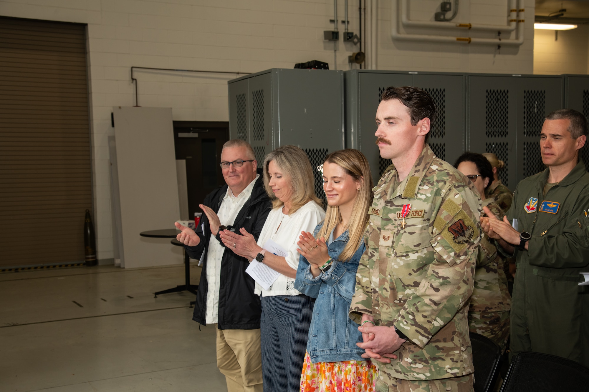 U.S. Air Force Staff Sgt. Justin Kahill, 227th Joint Terminal Attack Controller, right, stands with his family during a Bronze Star Medal and Casing of the Colors Ceremony at the 177th Fighter Wing, Egg Harbor Township, New Jersey, May 4, 2025. The Bronze Star is awarded to service members who distinguish themselves by heroic or meritorious achievement or service in a combat zone. The Casing of the Colors Ceremony marks a transition of a unit, whether that be inactivation, relocation, or deployment.