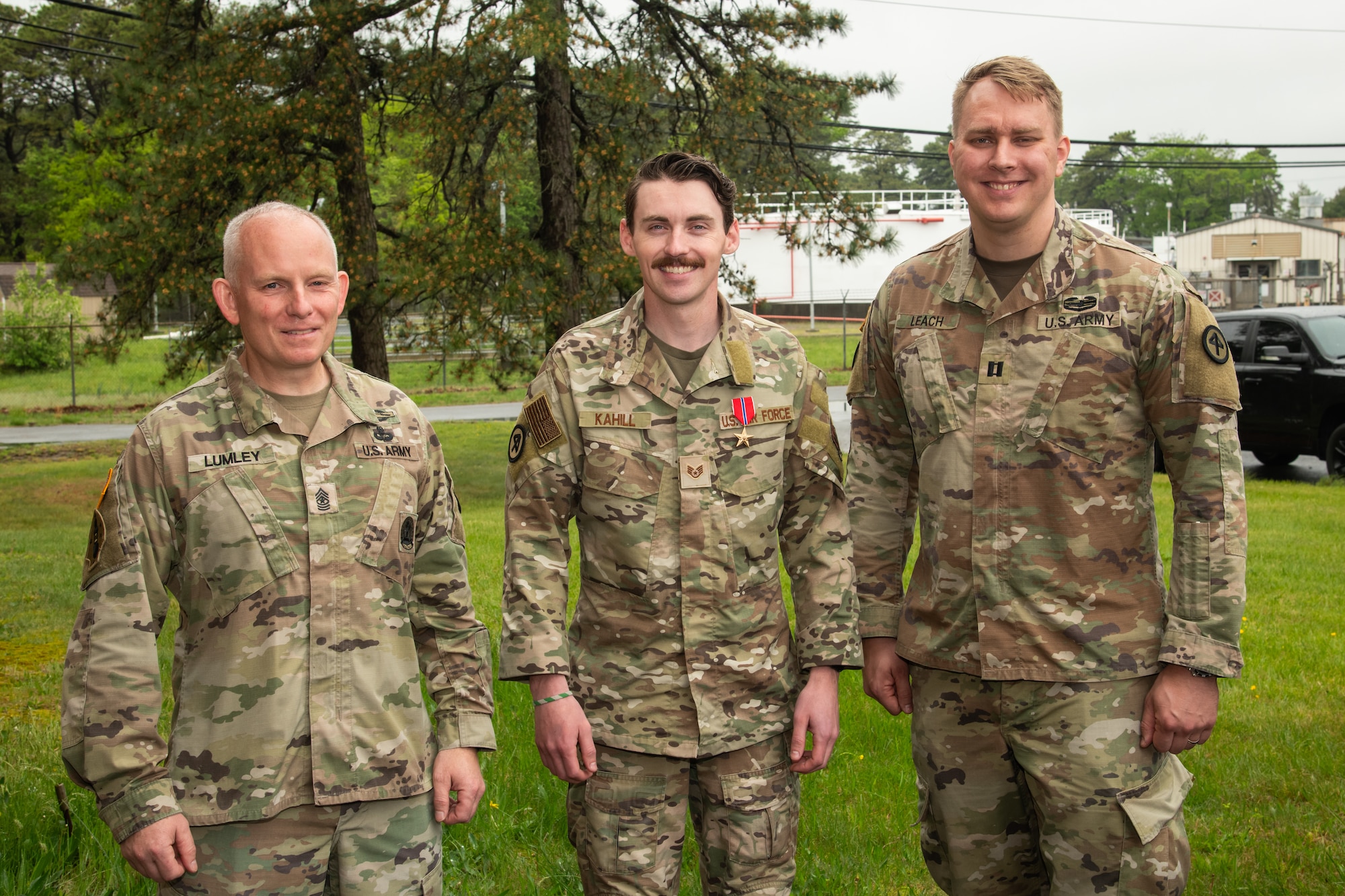 From left, U.S. Army Sgt. Maj. Ian Lumley, Operations Sergeant Major of the 1st Battalion, 114th Infantry New Jersey Army National Guard, Air Force Staff Sgt. Justin Kahill, 227th Joint Terminal Attack Controller, and Army Capt. David Leach, 3rd Battalion, 112th Field Artillery Officer, pose for a picture at the 177th Fighter Wing, Egg Harbor, New Jersey, May 4, 2025. Kahill was awarded the Bronze Star Medal for his meritorious service in a combat zone from March 2024 to Nov. 2024.