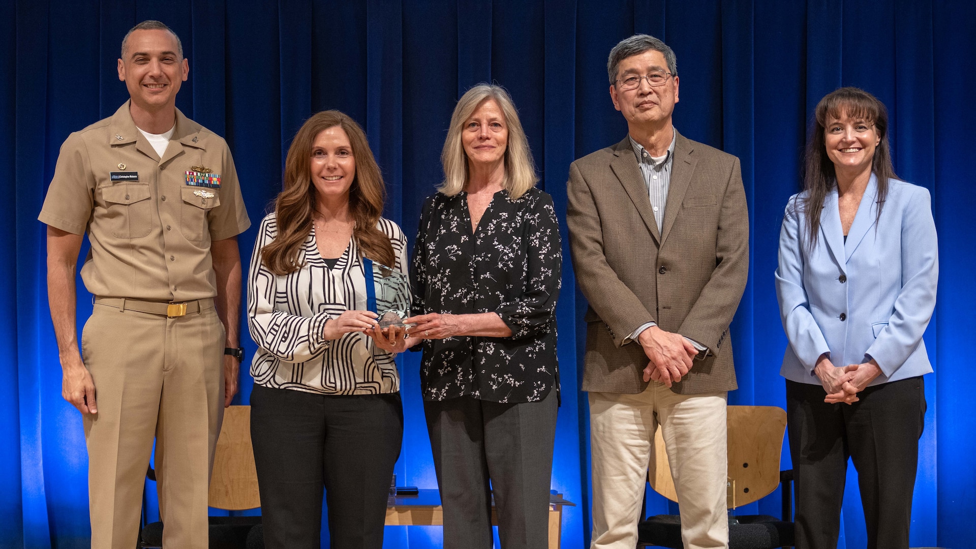 The High-Performance Computer Cluster (HPC) Lease Award Team receives the Honorary Team Award at the Carderock Division Honors. Pictured (L to R): Capt. Christopher Matassa, Lacey Pierce, Patricia McCarthy, Acting Technical Director Dr. Paul Shang, and Corporate Operations Department Head Tamar Gallagher