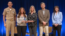 The High-Performance Computer Cluster (HPC) Lease Award Team receives the Honorary Team Award at the Carderock Division Honors. Pictured (L to R): Capt. Christopher Matassa, Lacey Pierce, Patricia McCarthy, Acting Technical Director Dr. Paul Shang, and Corporate Operations Department Head Tamar Gallagher