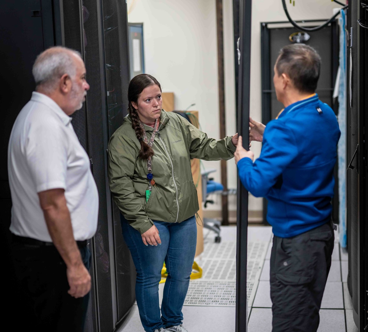 Penguin Computing personnel on site during HPC server installation May 9, 2025. As part of a first-of-its-kind lease agreement, Kelsey N. Beall (center), an engineer from Penguin, will work full-time alongside Carderock SeaTech engineers to provide routine updates, troubleshooting, and system support.