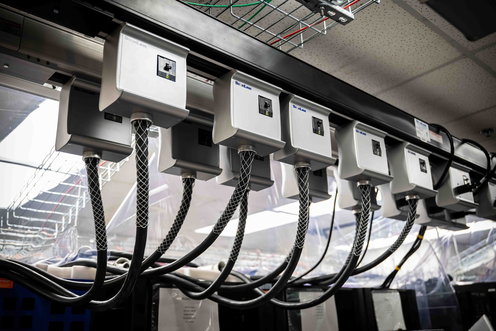 NSWC Carderock, West Bethesda, Md. | A close-up view of the overhead track busway system that manages the power-supply for the new High-Performance Computing servers in Carderock's Ship Engineering and Analysis Technology Center (SEATech).