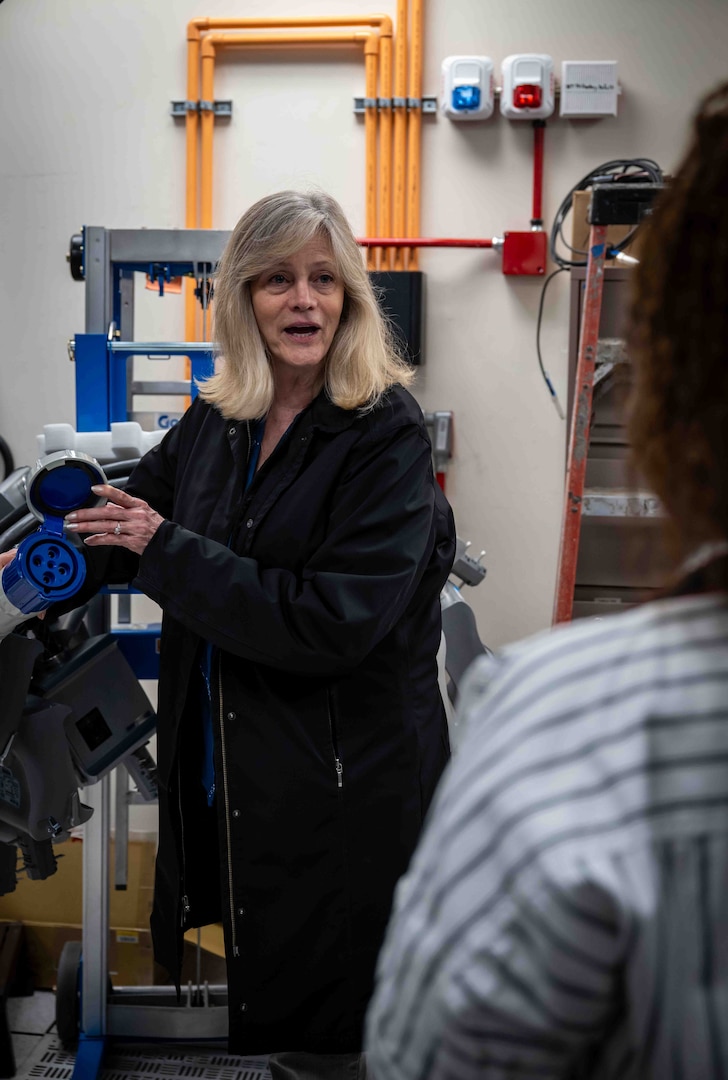 Patricia McCarthy, head of the Enterprise Services Branch, explains the track busway power supply system to employees. The system will be used to provide consistent and reliable power to the upgraded High-Performance Computing servers in Carderock's Ship Engineering and Analysis Technology Center (SEATech).