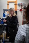 Patricia McCarthy, head of the Enterprise Services Branch, explains the track busway power supply system to employees. The system will be used to provide consistent and reliable power to the upgraded High-Performance Computing servers in Carderock's Ship Engineering and Analysis Technology Center (SEATech).