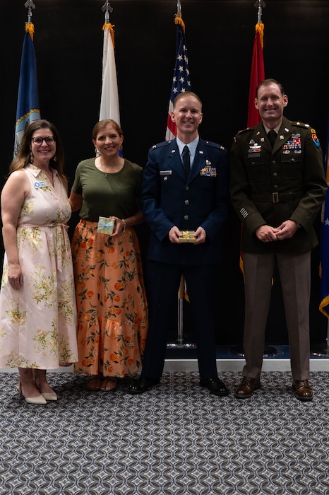 U.S. Air Force Col. Thomas “TK” Wilson, 17th Training Wing deputy commander, Lt. Col. Raymond Kuderka, 344th Military Intelligence Battalion commander, and Britta Todd, Goodfellow Spouse and Community member, receive a token of appreciation from Donyala Pierce, GSC vice president, during the 11th Annual GSC Scholarship and Awards Banquet at the Powell Event Center, Goodfellow Air Force Base, Texas, May 17, 2025. Wilson, Kuderka and Todd were a part of a five person judge panel that helped judge and rate scholarship applications to ensure the best candidates were chosen to receive them. (U.S. Air Force photo by Airman 1st Class Brian Lummus)