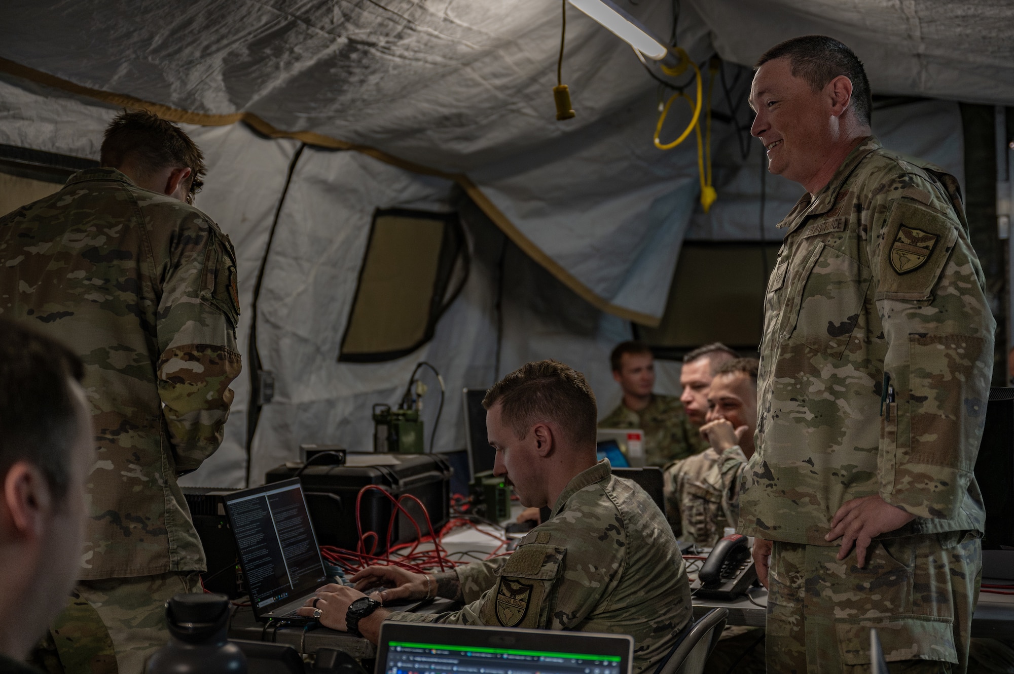 U.S. Airmen assigned to the 612th Air Operations Center (AOC) and 612th Air Communications Squadron conduct command and control operations during a mock deployment at Nellis Air Force Base, Nevada, May 13, 2025. Traditionally facilitated in a fixed, robust, secure location, the AOC-deployable team maintained operations despite a contested, degraded and operationally limited environment. (U.S. Air Force photo by Airman 1st Class Jennifer Nesbitt)