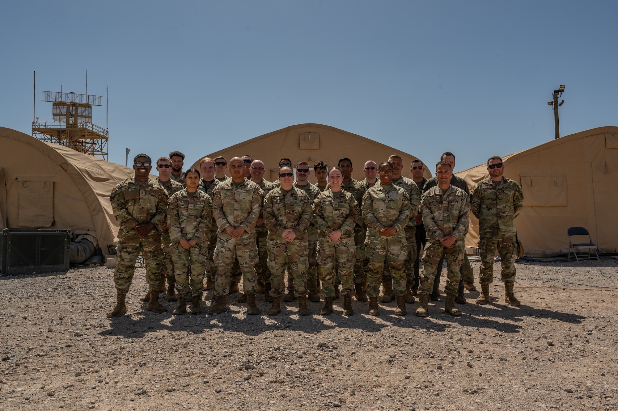 U.S. Airmen assigned to the 612th Air Operations Center (AOC) and 612th Air Communications Squadron stand for a photo during a mock deployment at Nellis Air Force Base, Nevada, May 13, 2025. As part of the exercise, the AOC-deployable team conducted a comprehensive test to assess the operational concept for a deployed C2 capability, ensuring mission readiness anytime, anywhere.  (U.S. Air Force photo by Airman 1st Class Jennifer Nesbitt)