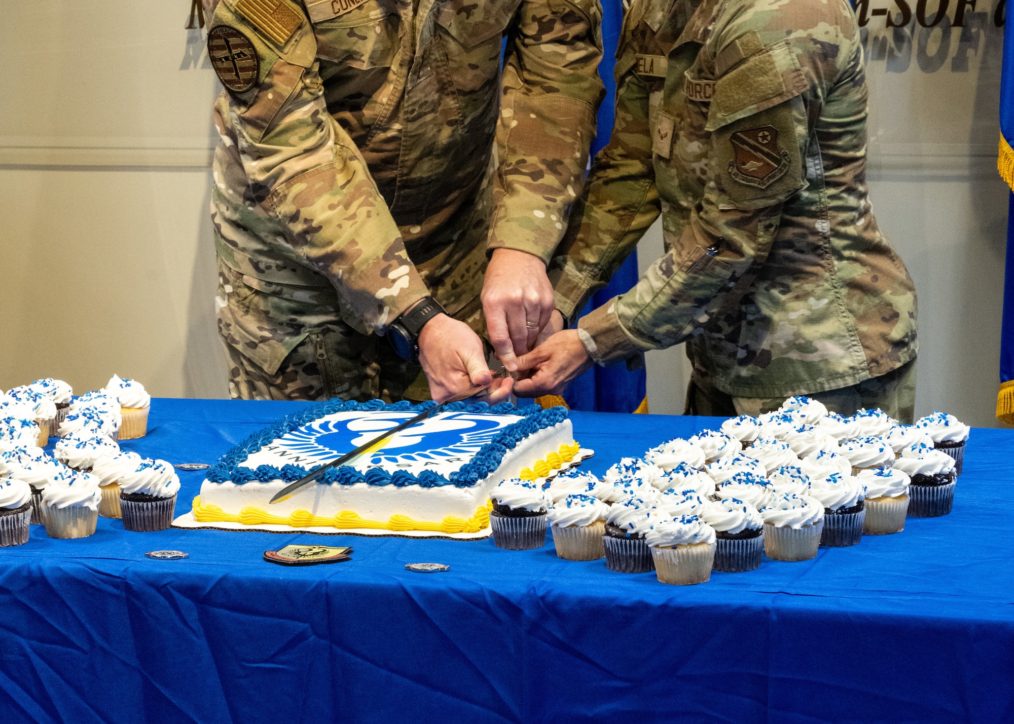 Airmen slice into a cake in honor of AFSOC’s 35th birthday.