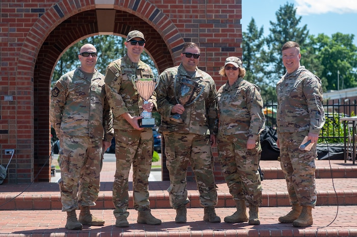 Airmen from the 375th Aeromedical Evacuation Squadron hold up a Squadron Cup after winning first place during the Warrior Challenge on Scott Air Force Base