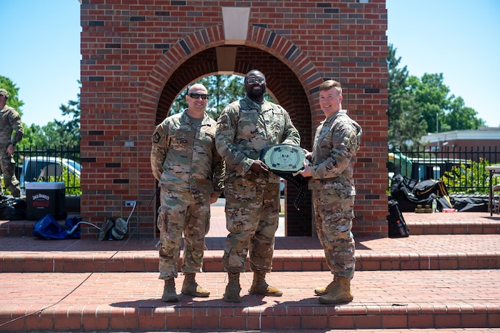 John Poole, 375th Air Mobility Wing commander, awards a championship belt to Senior Airman David Bailey from the 375th Force Support Squadron, following the pugil stick tournament during the Warrior Challenge at Scott Air Force Base