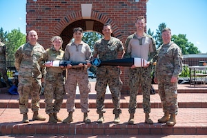 Members from the U.S. Transportation Command pose after winning the Warrior Challenge at Scott Air Force Base, Illinois, May 22, 2025. Their team earned first place after competing in a series of physically and mentally demanding events designed to test tactical readiness and teamwork