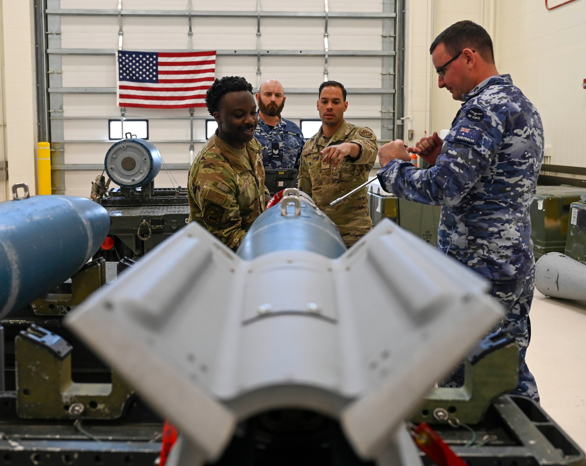 U.S. Air Force Airmen and Royal Australian Air Force Airmen assemble a GBU-12 Paveway II laser-guided dummy munition during the Combat Ammunition Production Exercise (CAPEX) at Eielson Air Force Base, Alaska, May 14, 2025.