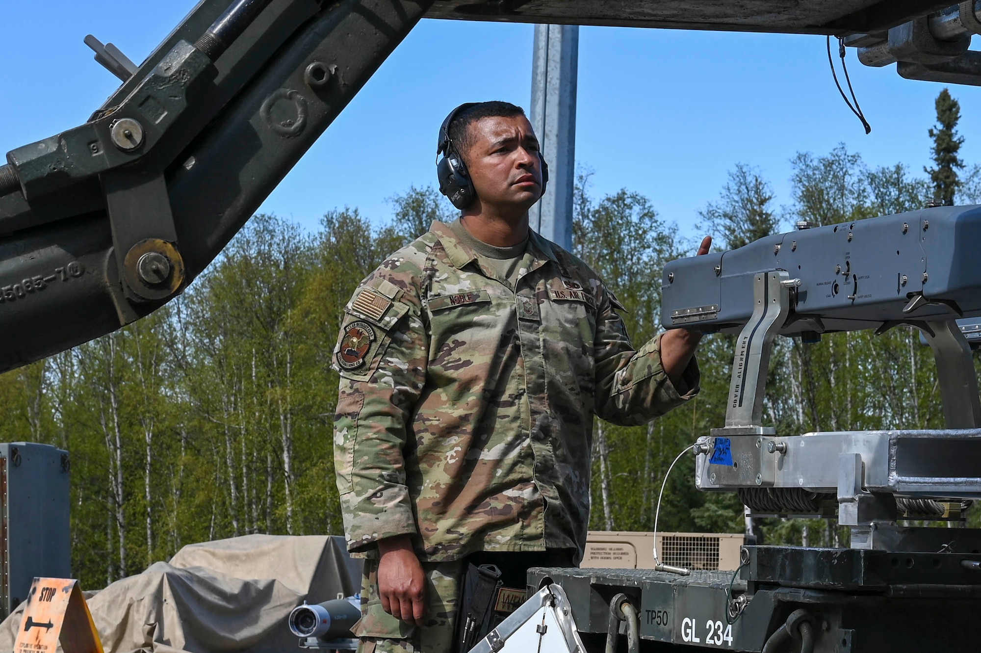 U.S. Air Force Master Sgt. Keith Noble, 354th Munitions Squadron armament flight chief, guides the arm of a MJ-1 lift truck during the Combat Ammunition Production Exercise (CAPEX) at Eielson Air Force Base, Alaska, May 14, 2025.