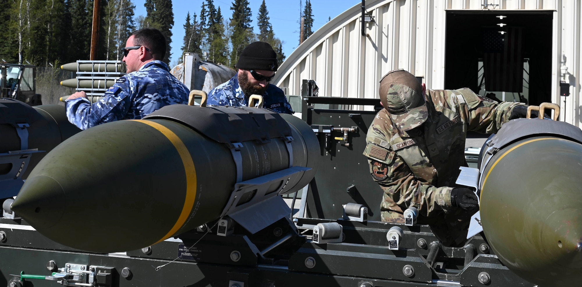(From left to right) Royal Australian Air Force Cpl. Kurt Thompson, 1st Squadron NCO armament technician, RAAF Sgt. Clinton Jordan, 1st Squadron SNCO armament technician, and U.S. Air Force Senior Airman Luke Scampone, 354th Munitions Squadron armament support technician, disassemble live ordnance during the Combat Ammunition Production Exercise at Eielson Air Force Base, Alaska, May 15, 2025.