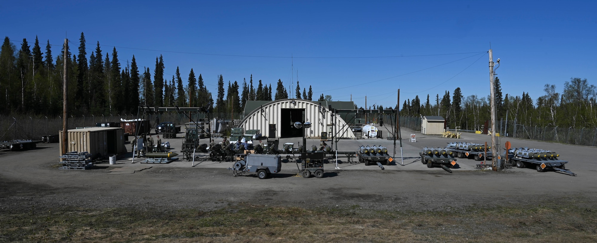 Royal Australian Air Force and U.S. Air Force Airmen disassemble ordnance during a Combat Ammunition Production Exercise (CAPEX) at Eielson Air Force Base, Alaska, May 15, 2025.