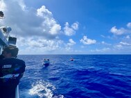The crew of the USCGC Myrtle Hazard (WPC 1139) arrive on scene with the 47-foot motor vessel Lucky Harvest adrift around 125 nautical miles west of Guam on May 16, 2025, and begin setting up the tow.