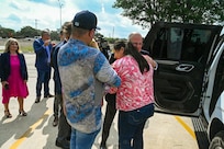 Tech. Sgt. Martha Rodriguez, a 433rd Security Forces Squadron fire team leader, embraces Jose Andrade, CEO of USAA, after receiving a new vehicle donated through USAA and the National Auto Body Council Recycled Rides program April 30, 2025 in San Antonio, Texas.