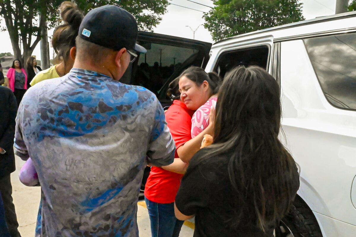 Tech. Sgt. Martha Rodriguez, a 433rd Security Forces Squadron fire team leader, embraces Lisa Hamlin, a retired 433rd Aeromedical Evacuation Squadron Chief Master Sgt., after receiving a new vehicle donated through USAA and the National Auto Body Council Recycled Rides program April 30, 2025 in San Antonio, Texas.