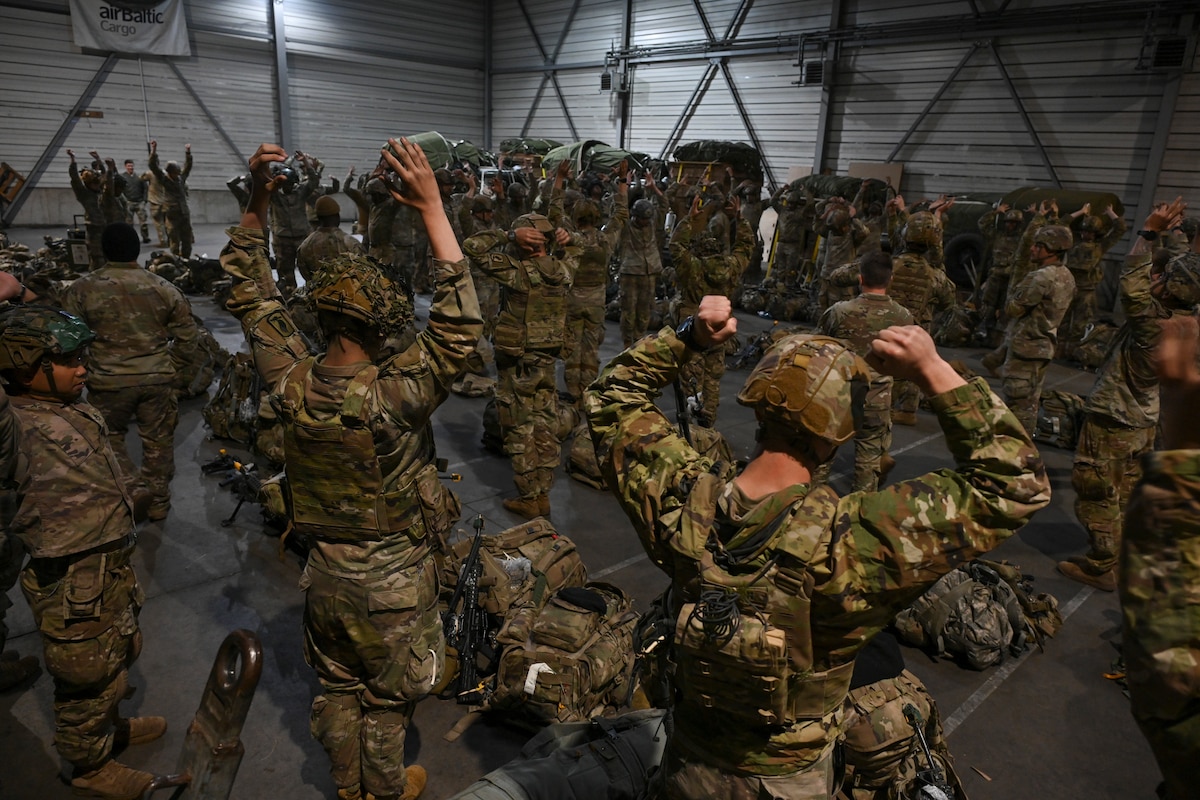 Paratroopers rehearse parachute landing fall drills during an exercise