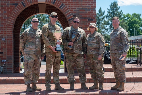 Airmen from the 375th Aeromedical Evacuation Squadron hold up a Squadron Cup after winning first place during the Warrior Challenge on Scott Air Force Base
