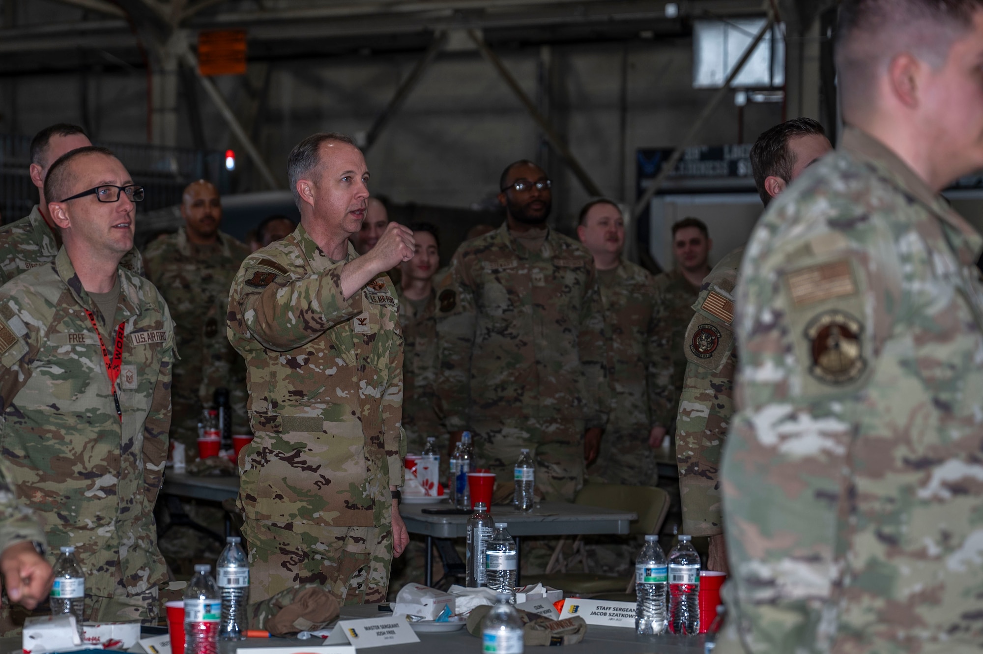 Col. Timothy Monroe, 319th Reconnaissance commander, sings the Air Force song with airmen from the 319th RW and the 28th Bomb Wing, at Grand Forks Air Force Base, N.D., April 25, 2025. The MPOY ceremony allowed for a time of camaraderie and support for the 28th BW airmen being recognized for their outstanding performance. (U.S. Air Force photo by Airman 1st Class Emma Funderburk)