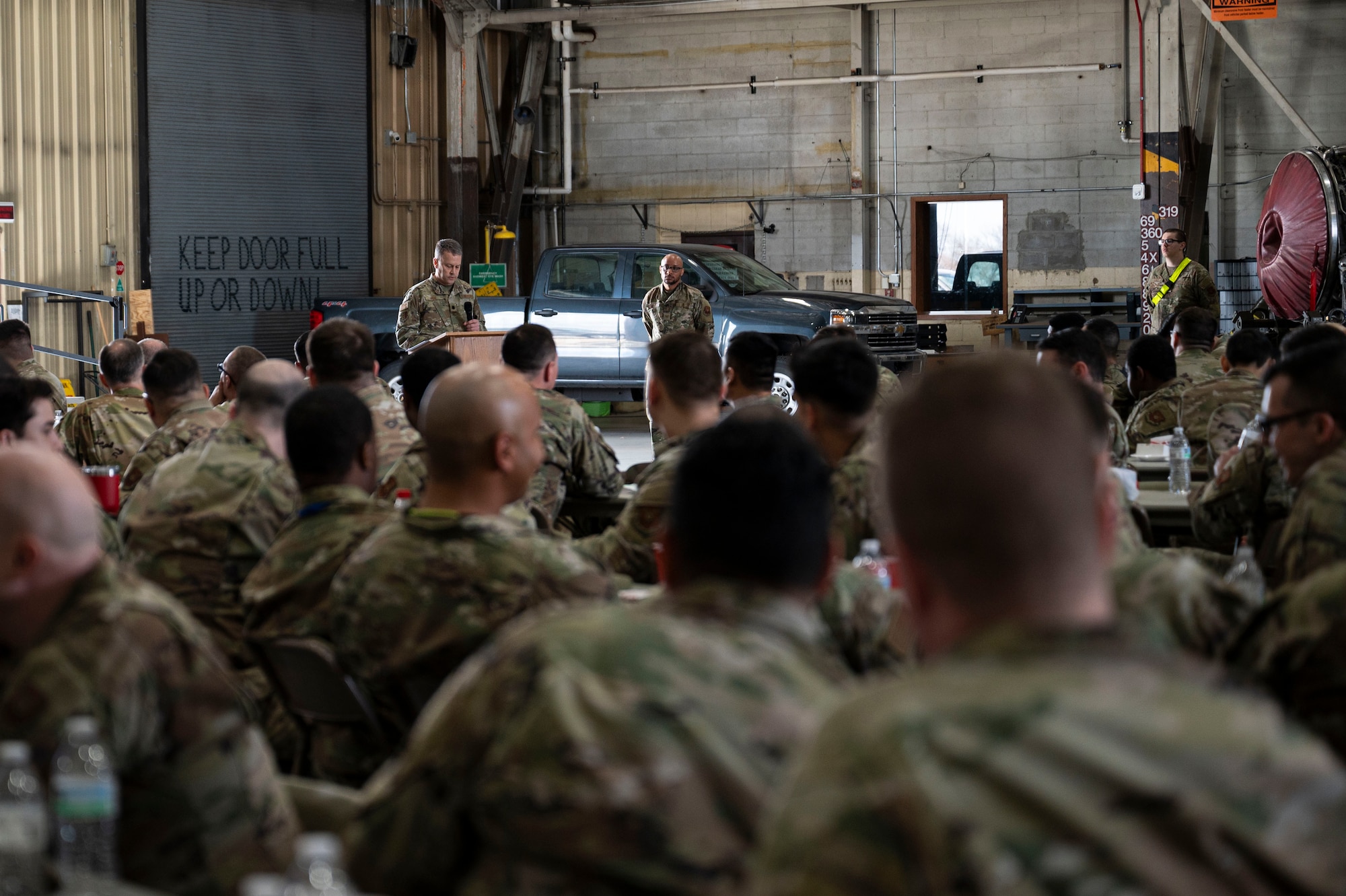 Lt. Col. Wilburn Poe, 28th Maintenance Group deputy commander, speaks to a crowd during the 28th MXG 2024 Maintenance Professional of the Year Awards ceremony at Grand Forks Air Force Base, N.D., April 25, 2025. The 28th MXG held a separate ceremony on Grand Forks AFB to celebrate the TDY airmen who were recognized as high performers. (U.S. Air Force photo by Airman 1st Class Emma Funderburk)