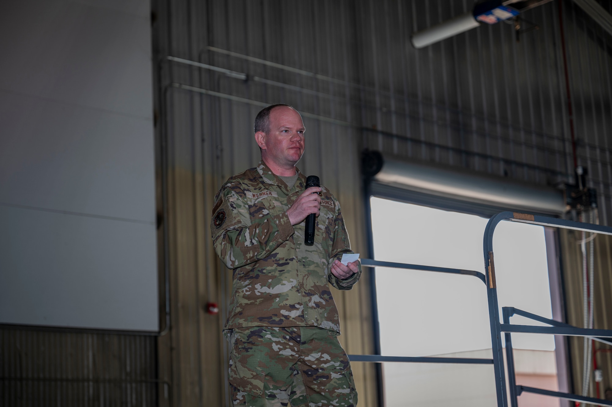 Chief Master Sgt. Daniel Werner, 37th Bomber Generation Squadron senior enlisted leader, speaks to a crowd during the 2024 Maintenance Professional of the Year awards ceremony at Grand Forks Air Force Base, N.D., April 25, 2025. During the ceremony, airmen in maintenance roles were recognized for going above and beyond. (U.S. Air Force photo by Airman 1st Class Emma Funderburk)